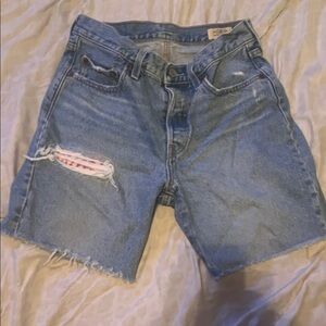 High-Rise Distressed Denim Shorts in Light Blue